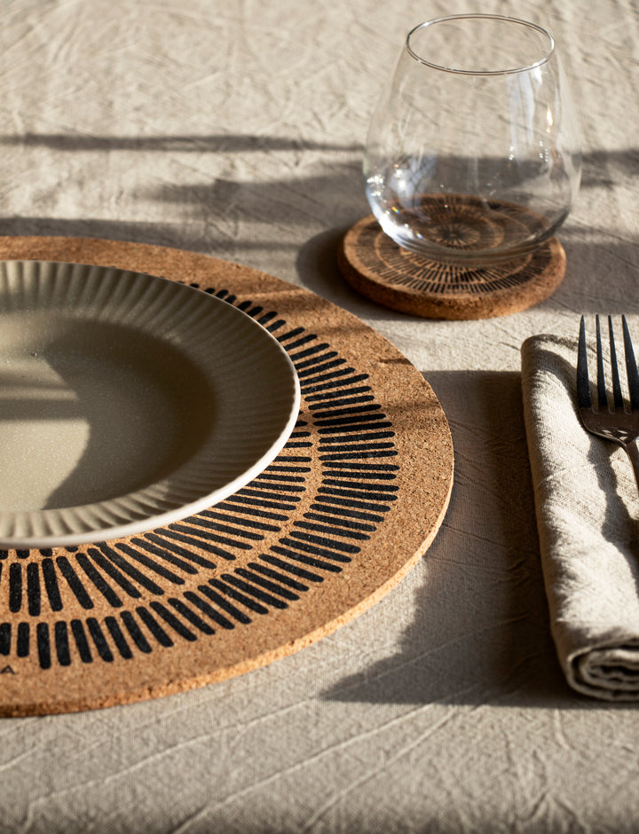 eco natural cork Printed Cork Mats set up on a table with a plate and cutlery